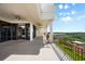 Long outdoor balcony featuring pillars and sliding doors with access to the interior of the house at 111 E Monument Ave # 801, Kissimmee, FL 34741