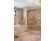 Spa-like bathroom featuring a soaking tub, walk-in shower, and travertine tiling at 111 E Monument Ave # 801, Kissimmee, FL 34741