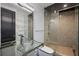 Modern bathroom with glass shower, glass sink, and accent lighting at 111 E Monument Ave # 801, Kissimmee, FL 34741
