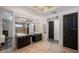 Large bathroom with double sinks, statement lighting, and tiled floors at 111 E Monument Ave # 801, Kissimmee, FL 34741