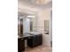 Bathroom vanity featuring a mirror and modern lighting fixtures at 111 E Monument Ave # 801, Kissimmee, FL 34741