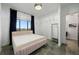 Bedroom with light pink bed frame, epoxy floor, and a view at 111 E Monument Ave # 801, Kissimmee, FL 34741
