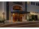Inviting building entrance with glass doors, exterior lighting, and prominent signage at 111 E Monument Ave # 801, Kissimmee, FL 34741