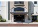 Elegant building entrance featuring detailed stonework, glass doors, and a welcoming design at 111 E Monument Ave # 801, Kissimmee, FL 34741
