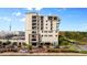 Exterior view of a modern building with balconies, multiple floors, and street parking at 111 E Monument Ave # 801, Kissimmee, FL 34741