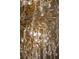 Close-up shot of a luxurious gold chandelier with crystal accents at 111 E Monument Ave # 801, Kissimmee, FL 34741