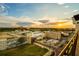 Rooftop view of a city landscape, showing building mural art and an expansive sunset sky at 111 E Monument Ave # 801, Kissimmee, FL 34741