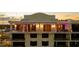 Condominium exterior featuring spacious balconies and refined architectural details is beautifully lit in the twilight at 111 E Monument Ave # 801, Kissimmee, FL 34741