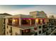 Close up aerial of a building's upper floors with decorative lighting, railings, and large windows at 111 E Monument Ave # 801, Kissimmee, FL 34741