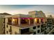 Elegant condominium featuring multiple balconies, large windows, and stylish architectural details at sunset at 111 E Monument Ave # 801, Kissimmee, FL 34741