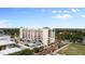 View of residential building featuring structured parking and landscaped green spaces at 111 E Monument Ave # 801, Kissimmee, FL 34741