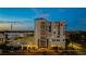 Stunning exterior view of a multi-story building with elegant architecture and street-level commercial spaces at 111 E Monument Ave # 801, Kissimmee, FL 34741