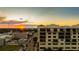 Stunning condominium building featuring balconies and situated in a vibrant downtown area during sunset at 111 E Monument Ave # 801, Kissimmee, FL 34741