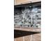 Close-up of a stylish kitchen faucet, sink, and a modern backsplash at 111 E Monument Ave # 801, Kissimmee, FL 34741