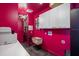 Bright pink laundry room with white cabinets, epoxy floors, and unique lighting at 111 E Monument Ave # 801, Kissimmee, FL 34741