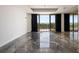 Sunlit living area with balcony access showcasing waterfront views and elegant drapery at 111 E Monument Ave # 801, Kissimmee, FL 34741