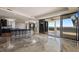 Spacious living room with elegant chandeliers and an open layout connecting to an outdoor balcony at 111 E Monument Ave # 801, Kissimmee, FL 34741