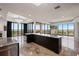Open floor plan with a chef's kitchen, bar, and floor-to-ceiling windows with city views at 111 E Monument Ave # 801, Kissimmee, FL 34741
