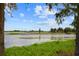 Picturesque water view framed by trees, showcasing a lighthouse in the distance at 111 E Monument Ave # 801, Kissimmee, FL 34741