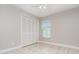 Neutral bedroom showcasing tile floors, overhead fan, and double closet at 11715 Sindlesham Ct, Orlando, FL 32837