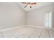 Neutral bedroom showcasing tile floors, overhead fan and an attached bath at 11715 Sindlesham Ct, Orlando, FL 32837