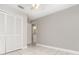 Bedroom featuring tile floors, overhead fan, and an attached bath at 11715 Sindlesham Ct, Orlando, FL 32837