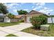 Nice single-story home with a two-car garage, a beautiful hibiscus bush, and a well-kept lawn at 11715 Sindlesham Ct, Orlando, FL 32837