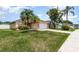 Inviting single-story home with palm trees, a well-maintained lawn, and a two-car garage at 11715 Sindlesham Ct, Orlando, FL 32837