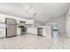 Modern kitchen with white cabinets, stainless steel appliances, granite countertops, and tile flooring at 11715 Sindlesham Ct, Orlando, FL 32837