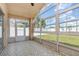 Bright sunroom with large windows, patterned tile flooring, and access to the backyard and the main house at 11715 Sindlesham Ct, Orlando, FL 32837
