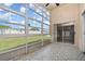 Enclosed sunroom featuring patterned tile floors, ceiling fan, and large windows overlooking the backyard at 11715 Sindlesham Ct, Orlando, FL 32837