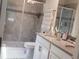 Bathroom with double sink vanity, tiled shower with glass door, and decorative accents at 11802 Pulitzer Pl, Orlando, FL 32832
