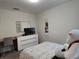 Bright bedroom featuring neutral walls, carpet floors, and a dresser with a TV at 11802 Pulitzer Pl, Orlando, FL 32832