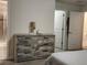 Bedroom featuring a wooden dresser, closet and bathroom door at 11802 Pulitzer Pl, Orlando, FL 32832