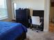 Bedroom featuring a dark bed, dresser and a computer desk at 11802 Pulitzer Pl, Orlando, FL 32832