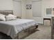 Serene bedroom features a bed with storage drawers, a vanity table with lighted mirror at 11802 Pulitzer Pl, Orlando, FL 32832