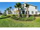 Attractive townhomes showcasing well-maintained landscaping and palm trees on a sunny street at 11802 Pulitzer Pl, Orlando, FL 32832