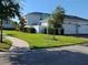 Well-maintained home with lush green lawn and manicured landscaping on a corner lot at 11802 Pulitzer Pl, Orlando, FL 32832