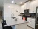Contemporary kitchen featuring quartz countertops, stainless steel appliances, and sleek white cabinets at 11802 Pulitzer Pl, Orlando, FL 32832