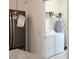 Laundry room featuring white appliances, a refrigerator, and storage shelves at 11802 Pulitzer Pl, Orlando, FL 32832