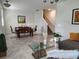 Inviting living area with tile floors, stylish furnishings, and a staircase at 11802 Pulitzer Pl, Orlando, FL 32832