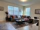 Comfortable living room with gray sectional sofa, area rug, and abundant natural light at 11802 Pulitzer Pl, Orlando, FL 32832