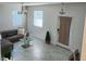 Cozy living room with a modern sofa, tile flooring, and natural light at 11802 Pulitzer Pl, Orlando, FL 32832