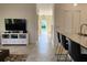 Open-concept living area with modern furniture and tile flooring at 11802 Pulitzer Pl, Orlando, FL 32832