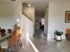 Bright and airy living area with tile floors, connecting to the dining space and staircase at 11802 Pulitzer Pl, Orlando, FL 32832