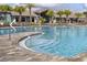Stunning community pool with inviting crystal clear water and tropical landscaping at 11802 Pulitzer Pl, Orlando, FL 32832