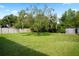 Expansive backyard featuring mature trees, shed, and lush green lawn at 1322 Morris Ave, Orlando, FL 32803