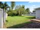 Spacious backyard with mature trees and a white vinyl fence at 1322 Morris Ave, Orlando, FL 32803