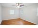 Bright bedroom featuring hardwood floors, a ceiling fan, and ample natural light at 1322 Morris Ave, Orlando, FL 32803