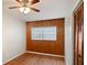 Bedroom featuring wood paneling, hardwood floors, and a large window at 1322 Morris Ave, Orlando, FL 32803
